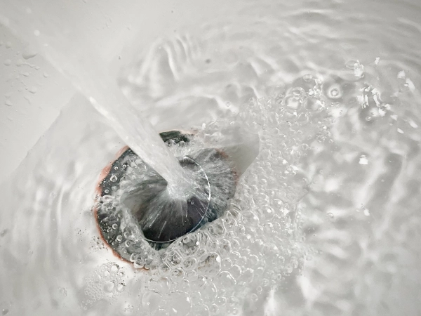 Water draining freely through a cleared household sink drain