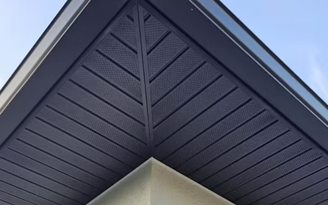 Finished dark fascia and soffit lining beneath a roof gable