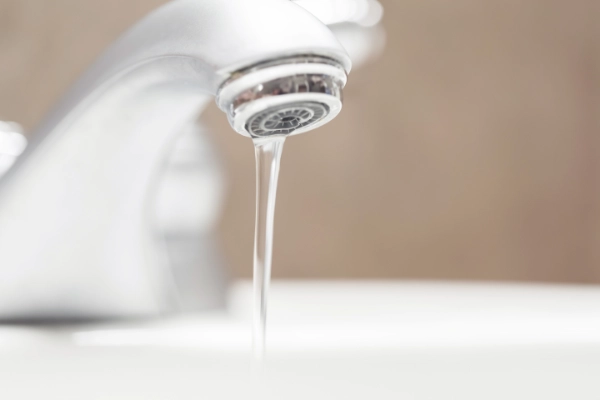 Water running from a household tap requiring repair