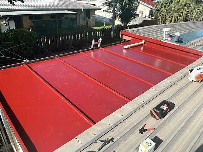 Red patio roof after re-pitching and new flashing installation