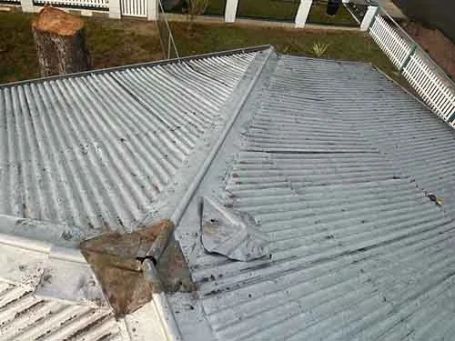 Weathered corrugated roof before replacement
