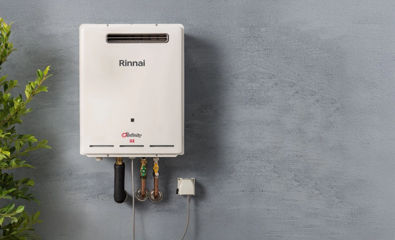 Rinnai Infinity 32 continuous-flow hot water system installed on an exterior wall